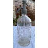 A glass soda syphon etched with 'Bratley Chemist Pontefract' made by Barnett and Foster, London.