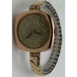 A 9ct gold ladies wristwatch, 22gm total weight on a rolled gold expanding strap.Condition