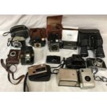 A selection of 11 cameras, Kodak brownies and others with a pair of Ventura 12 x 50 binoculars.