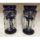 A pair of blue glass lustres with gilt and hand painted floral decoration and heavy glass