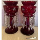 A pair of Victorian ruby glass lustres with enamelled floral decoration to top. 36cm h.Condition