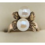 Ring marked 14K, leaf design set with two pearls, size L, weight 4.3gm.Condition ReportGood