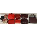 Eleven leather hand bag and purses in red hues to include a maroon two handled handbag 28 w x 35.5cm