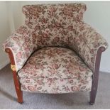 An Edwardian upholstered floral bedroom chair with mahogany and inlay to arms. 79 h x 75 w x 75cm