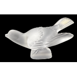 A Lalique Crystal frosted glass Sparrow sculpture with wings outstretched and paper label to tail.