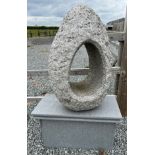 A quartz/ granite egg shaped garden sculpture on stand with internal light. 144 cm h on stand.