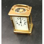 A brass carriage clock with Swiss movement. 14cms h with handle up. Key included. Winds and goes.