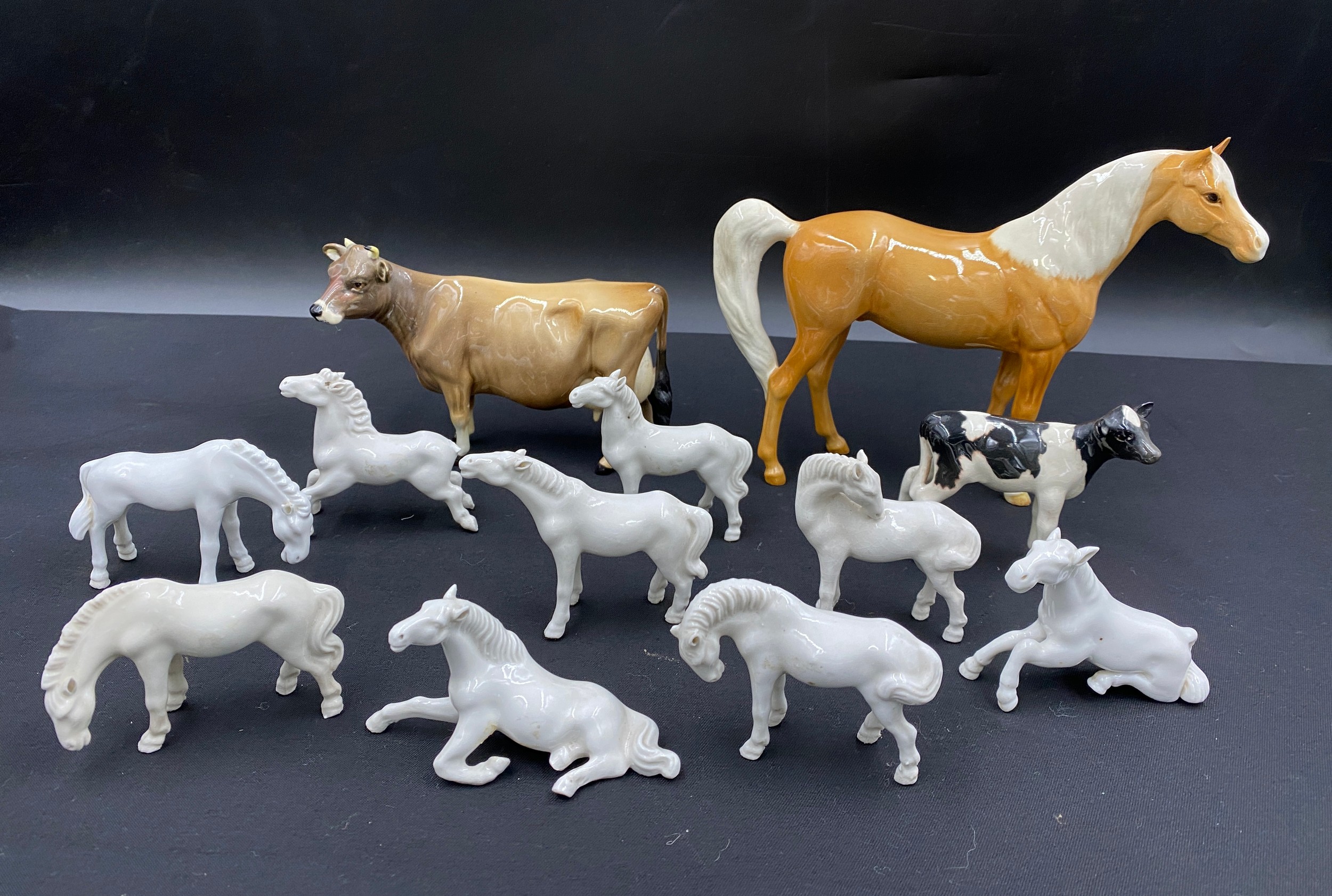 A collection of ceramic horses and cattle to include three Beswick, Beswick horse height 16cm and