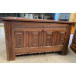 An oak coffer with internal candle box and 2 zinc lined compartments, carved to front. 119 w x 58