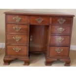 A 19thC mahogany kneehole desk with brass fittings and ogee bracket feet. 95 w x 50 d x 82cm d.