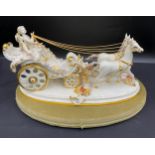 A large Capodimonte figure of Horses and Carriage with gilt decoration. With a disassociated stand.
