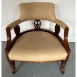 A 19thC upholstered open armchair, turned front legs on castors. 36cm h to seat, 70cm h to back.