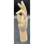 A wooden articulated artists hand model. 29cm h.