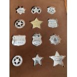 A framed set of twelve Sterling silver Replica American Police, Sheriff, Ranger and Marshal