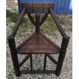 Oak carved back Turners chair, bubble turned arms, circular legs. Height to seat 47cm, height to