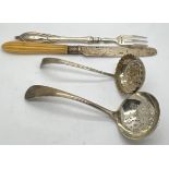 Silver to include; two sifter spoons, silver bladed knife and a fork, sifter with bright cut