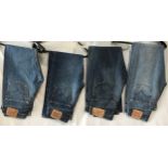 A selection of four vintage Levi's 501 denim jeans. sizes from right to left 29 x 32, 34 x 30, 29