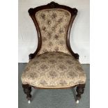 A 19th C upholstered nursing chair. Turned supports on ceramic castors. 89cm h to top.Condition