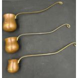 A set of three graduated copper and brass toddy ladles engraved 'Whisky', 'Rum' and 'Brandy'.