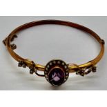 Edwardian 9ct gold bangle with amethyst and seed pearls. 7gm.Condition ReportSplit to gold.