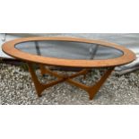 A mid century oval topped coffee table with glass top insert. 107 x 54 x 42cm h.Condition ReportGood