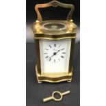 A Henley brass carriage clock with original key case. 16cm h with handle x 8.5cm w x 7cm d.Condition
