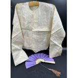 A Chinese cream silk jacket with pockets, labelled Sein Bros together with a bone and silk fan 33 cm