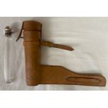 Glass tier drop flask with metal stopper in a leather case. Bottle height 25cms, max width 5.5cms.