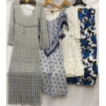 A selection of vintage dresses to include a silver crocheted long 1970's dress, blue and white