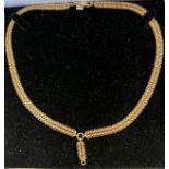 An 18ct gold chain necklace with central drop. Necklace approx 50cm l plus drop. 32.8gm.Condition