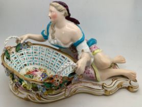 A John Bevington figural sweetmeat basket modelled as a classical lady seated by a shell shaped oval