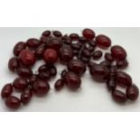 A quantity of cherry amber beads to include 2 necklaces and other loose beads. 164gm total weight.