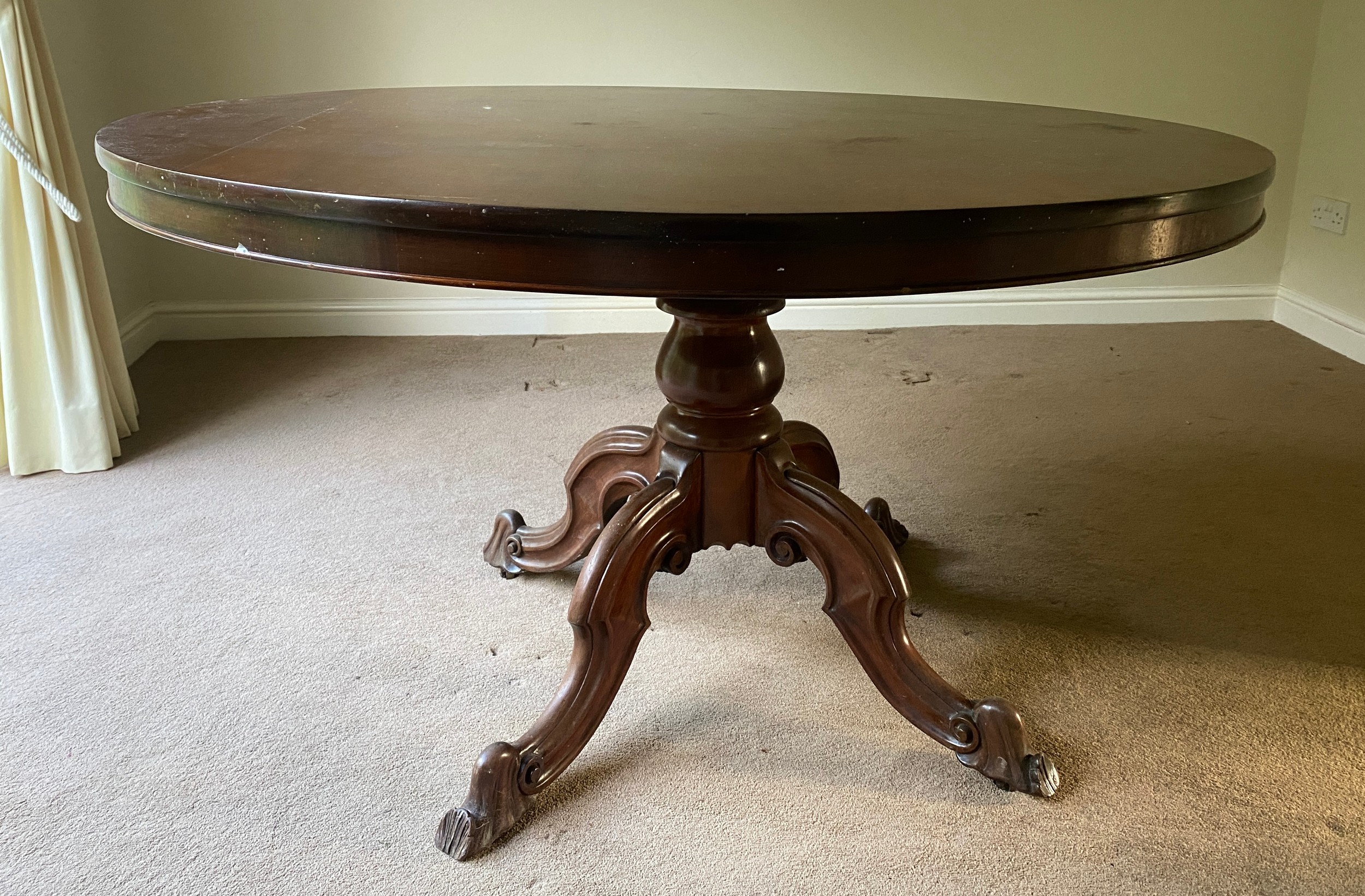 A mahogany Victorian tip top dining table on turned legs and tripod base. 132 diameter x 77cm h.