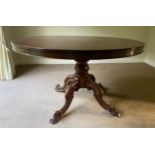 A mahogany Victorian tip top dining table on turned legs and tripod base. 132 diameter x 77cm h.