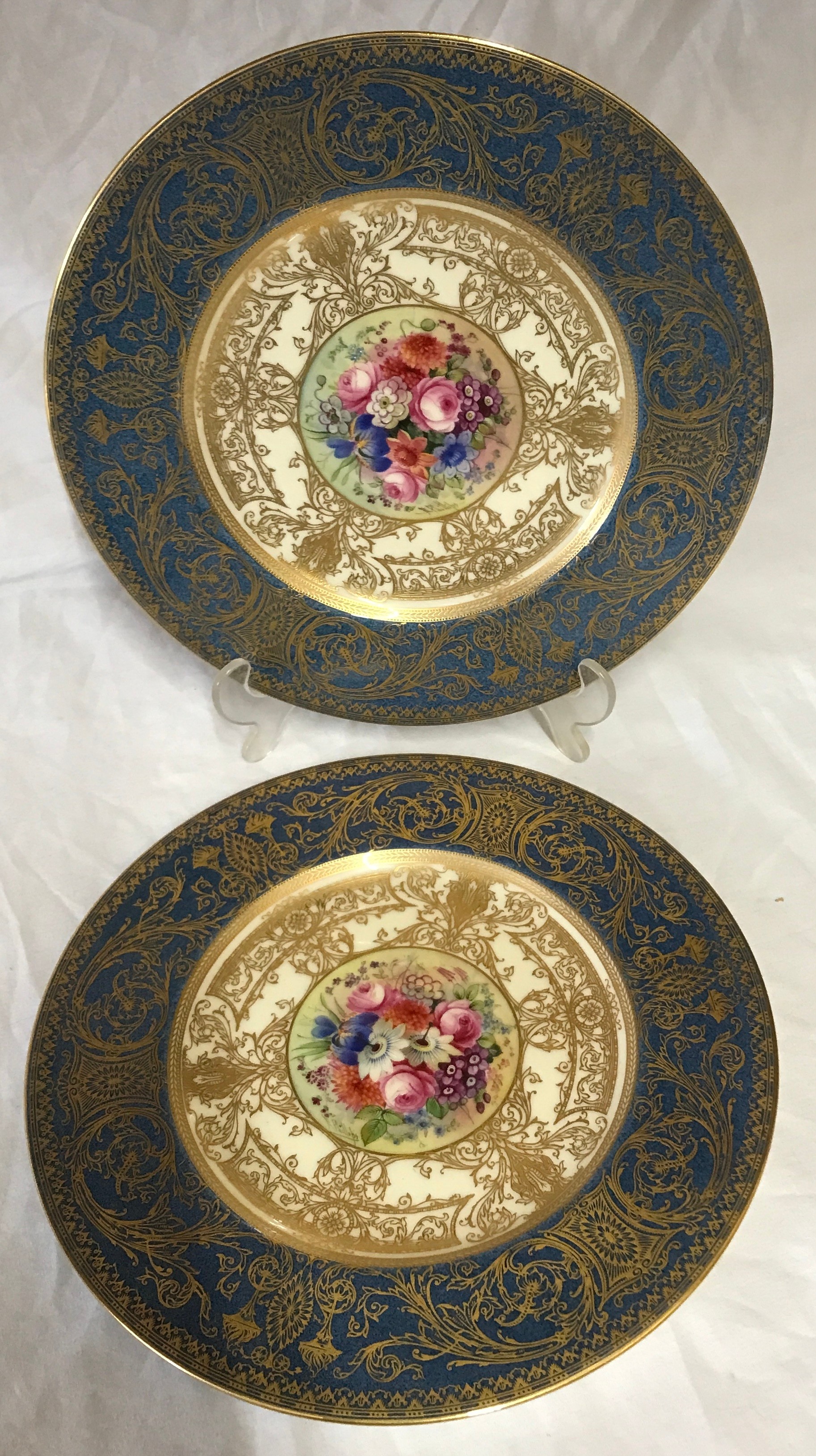 Pair of hand painted Royal Worcester plates signed E Phillips, 27cm d. Depicting flowers to the