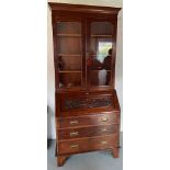 An Edwardian walnut bureau bookcase with well carved fallfront. 92 w x 46 d x 218cm h.Condition