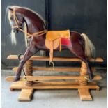 A good quality wooden rocking horse with leather saddle, bridle etc. Horse 101cm w.Condition