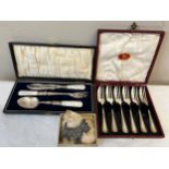 Boxed cake forks, boxed Mother of Pearl handled spoon knife and fork and a dog brooch.