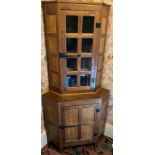 Peter Heap Rabbitman , an oak standing corner cupboard, panelled with a glazed door over a