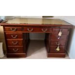 A mahogany kneehole desk with cream leather top.Condition ReportGood condition.