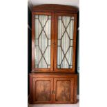 A 19thC mahogany glazed bookcase on two door base, with astral glazed doors and arched pediment. 260