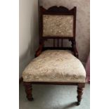 Edwardian mahogany upholstered nursing chair on castors. 35cm to height of seat. 95cm h to back.