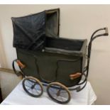 A vintage dolls pram.Condition ReportReplacement leather straps.
