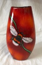 A Poole Pottery vase with Bee decoration to front on a red and orange glazed background. 25cms h.
