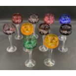 Ten coloured glass hock glasses with faceted stems. 20cm h.Condition ReportGood condition.