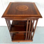 A mahogany and inlaid revolving book stand. Top 50cm d x 83cm h. On castors.Condition ReportGood