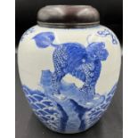 A Chinese porcelain blue and white ginger jar 22cm h with carved hardwood cover, possibly Kangxi.