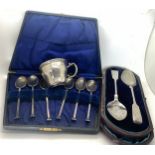 Hallmarked silver spoons and a cup marked 800. Total weight 140.4gms.