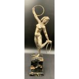 A silvered bronze semi-clad hoop dancer on a black marbled plinth, signed to rear Pierre Laurel.