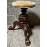 A Victorian mahogany revolving piano stool with adjustable seat and tripod base.Condition